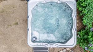 a bath tub filled with water in a garden at Pete's Place by Juniper Holiday + Home in Sawyer