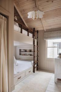 a bedroom with two bunk beds and a chandelier at Townie 2 - The Sage by Juniper Holiday + Home Unit in Union Pier