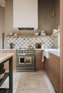 a kitchen with a stove and a sink at Townie 2 - The Sage by Juniper Holiday + Home Unit in Union Pier