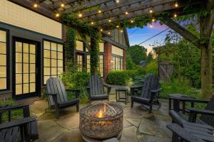 an outdoor patio with chairs and a fire pit at Black Door Bungalow by Juniper Holiday + Home in Lakeside