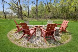 three chairs and a fire pit in a yard at The Birdcage by Juniper Holiday + Home in Douglas