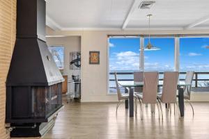 a dining room with a fireplace and a table and chairs at Lake Michigan Getaway by Juniper Holiday + Home in New Buffalo