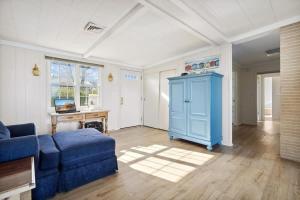 a living room with a blue couch and a table at Lake Michigan Getaway by Juniper Holiday + Home in New Buffalo +30 photos
