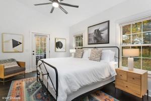 a bedroom with a bed and a ceiling fan at The Dakota by Juniper Holiday + Home in Union Pier