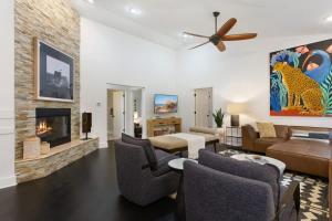 a living room with a couch and a fireplace at The Dakota by Juniper Holiday + Home in Union Pier