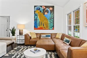 a living room with a couch and a table at The Dakota by Juniper Holiday + Home in Union Pier +26 photos