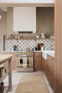 a kitchen with a stove and a sink at Townie 3 - The Moss by Juniper Holiday + Home in Union Pier