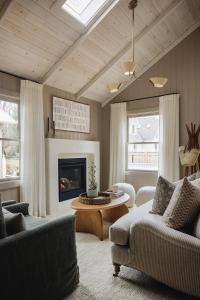a living room with a couch and a fireplace at Townie 3 - The Moss by Juniper Holiday + Home in Union Pier