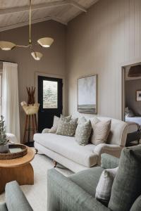 a living room with a white couch and a bed at Townie 3 - The Moss by Juniper Holiday + Home in Union Pier +22 photos