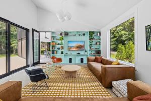 a living room with a couch and a table at Owlwood by Juniper Holiday + Home in Harbert