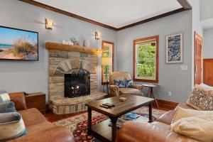 a living room with a couch and a fireplace at The Moose House by Juniper Holiday + Home in New Buffalo