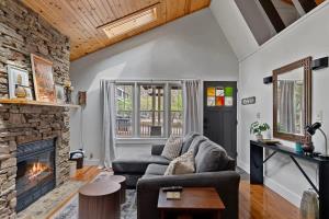 a living room with a couch and a fireplace at Meadow Pines by Juniper Holiday + Home in Michigan City