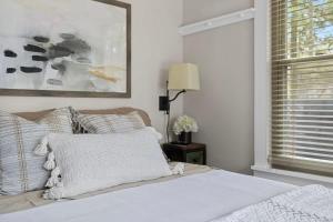 a bedroom with a bed and a picture on the wall at Meadow Pines by Juniper Holiday + Home in Michigan City