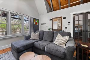 a living room with a couch and a table at Meadow Pines by Juniper Holiday + Home in Michigan City