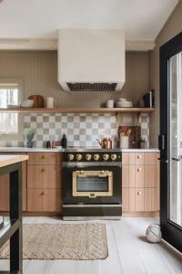 a kitchen with a black oven in a kitchen at Townie 4 - The Fern by Juniper Holiday + Home in Union Pier