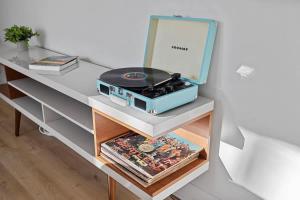 a table with a record player on top of it at The High Life by Juniper Holiday + Home in New Buffalo