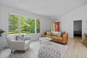 a living room with two chairs and a couch at The High Life by Juniper Holiday + Home in New Buffalo