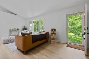a living room with a couch and a large window at The High Life by Juniper Holiday + Home in New Buffalo +39 photos