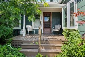 a front porch of a blue house with stairs at The Fourth Oak by Juniper Holiday + Home in Three Oaks +22 photos