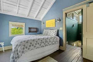 a bedroom with a bed and a blue wall at The Fourth Oak by Juniper Holiday + Home in Three Oaks