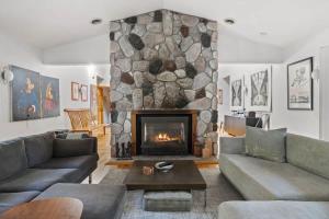 a living room with a large stone fireplace at Casa Azur by Juniper Holiday + Home in Union Pier