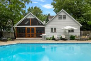 a house with a swimming pool in front of a house at Casa Azur by Juniper Holiday + Home in Union Pier