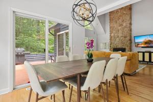 a dining room with a wooden table and chairs at Gray Haven by Juniper Holiday + Home in Union Pier