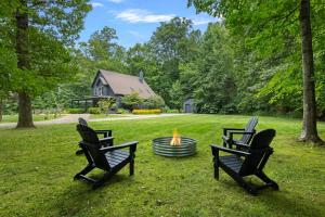 two chairs and a fire pit in a yard at Gray Haven by Juniper Holiday + Home in Union Pier