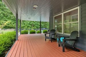 a porch with two chairs and a table on a house at Gray Haven by Juniper Holiday + Home in Union Pier +35 photos