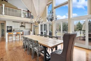 a kitchen and dining room with a wooden table and chairs at Main Destination by Juniper Holiday + Home in Grand Beach