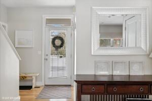 a white room with a mirror and a door at Schoolhouse Rock by Juniper Holiday + Home in New Buffalo