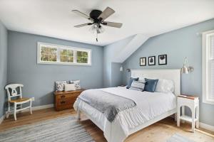 a bedroom with a bed and a ceiling fan at Greystone Cottage by Juniper Holiday + Home in Union Pier