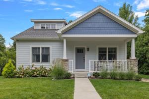 a house with a green lawn at Greystone Cottage by Juniper Holiday + Home in Union Pier