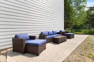 a group of wicker chairs with blue cushions on a patio at Sandy Shores in South Haven +34 photos