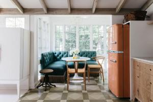 a kitchen with a green couch and a table at Leo Cottage by Juniper Holiday + Home in Union Pier