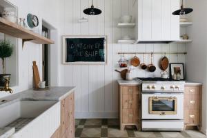 a kitchen with a stove and a counter top at Leo Cottage by Juniper Holiday + Home in Union Pier