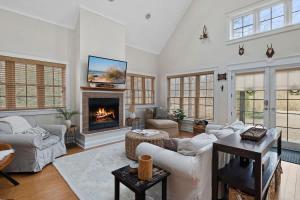 a living room with a couch and a fireplace at Deer Haus by Juniper Holiday + Home in New Buffalo