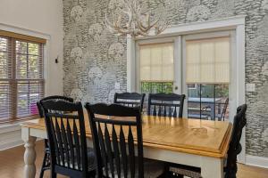 a dining room with a wooden table and chairs at Deer Haus by Juniper Holiday + Home in New Buffalo +35 photos