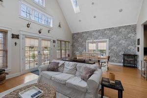 a living room with a couch and a table at Deer Haus by Juniper Holiday + Home in New Buffalo