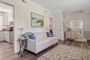 a living room with a white couch and a staircase at Whispering Arbor by Juniper Holiday + Home in Lakeside +32 photos