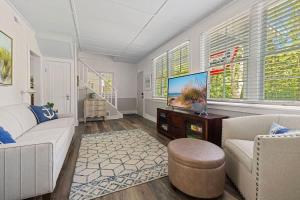 a living room with a couch and a tv at Whispering Arbor by Juniper Holiday + Home in Lakeside