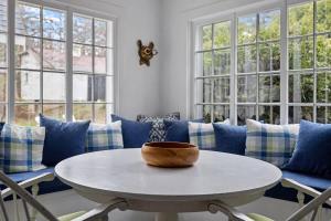 a living room with a white table and blue couch at Rabbit Run by Juniper Holiday + Home in Sawyer +68 photos