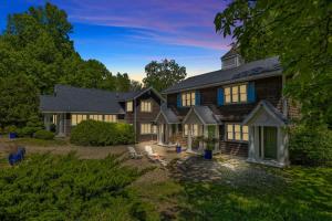 a large house with a gambrel roof at Rabbit Run by Juniper Holiday + Home in Sawyer