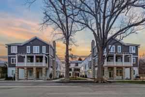 a row of houses on a street at sunset at The Happy Place by Juniper Holiday + Home in Union Pier
