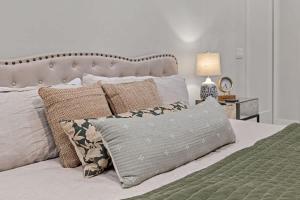 a bedroom with a bed with pillows on it at The Happy Place by Juniper Holiday + Home in Union Pier