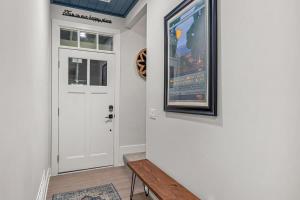 a door with a picture and a bench next to it at The Happy Place by Juniper Holiday + Home in Union Pier +47 photos