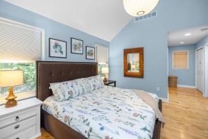 a bedroom with a bed and a window at Blue Beech Cottage in Union Pier