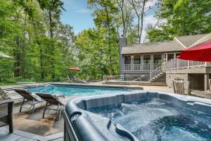a swimming pool in front of a house at Hearth & Timber in Bridgman