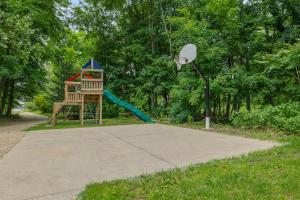 a playground with a slide and a basketball hoop at Hearth & Timber in Bridgman