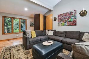 a living room with a couch and a table at Hearth & Timber in Bridgman +48 photos